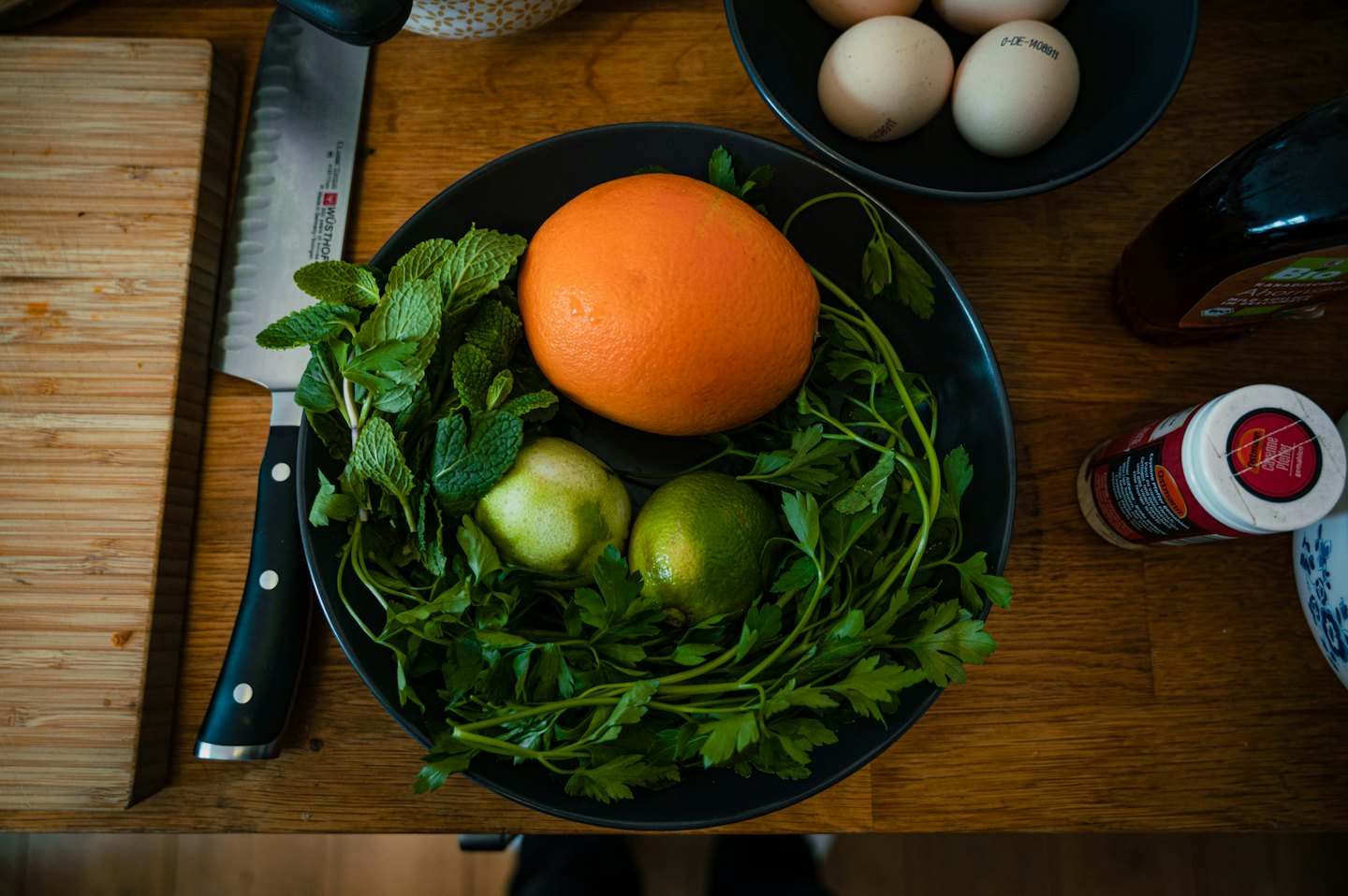 Fresh cooking ingredients arranged on a wooden counter for meal prep.